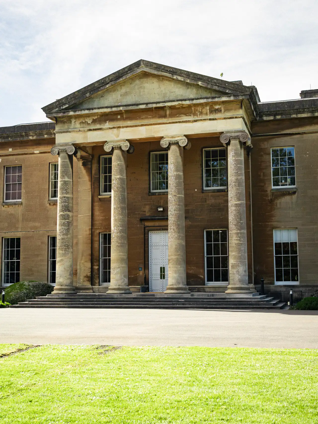 Utility-style head-on view of the mansion.
